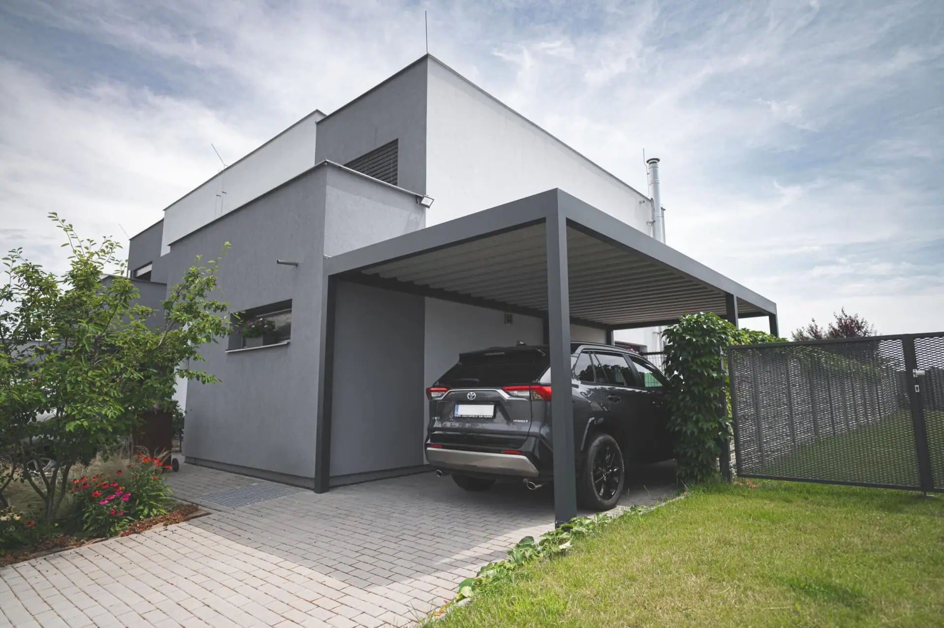 Casă modernă gri și albă cu carport și grădină